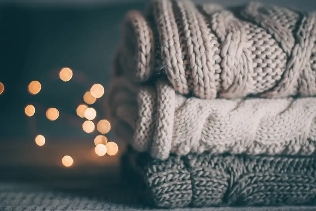 Minimalist holiday season. Stack of sweaters.