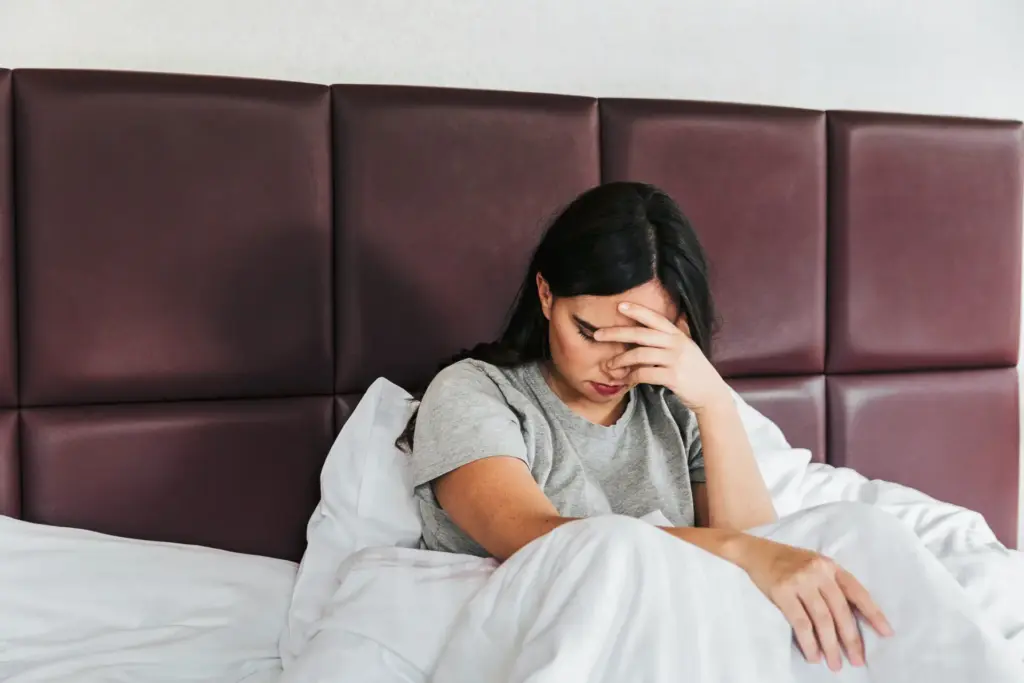 Female lying in bed and having sleeping problems