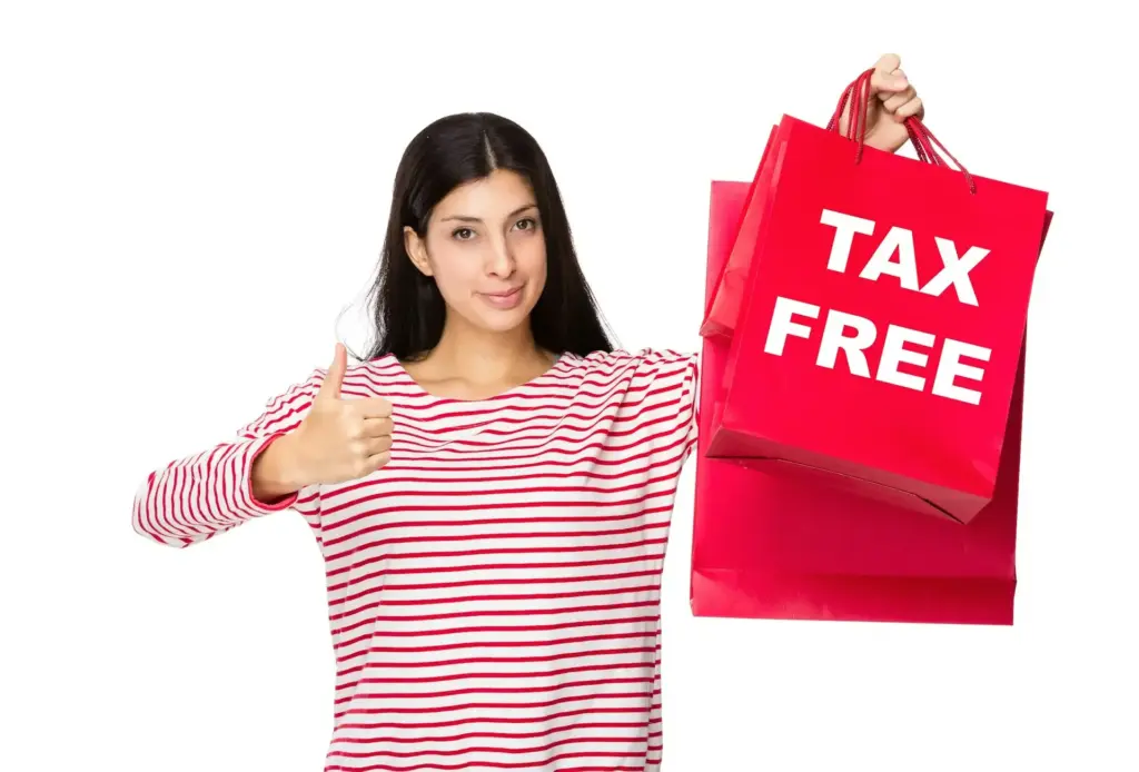 Woman with thumb up gesture and holding shopping bag for showing tax free