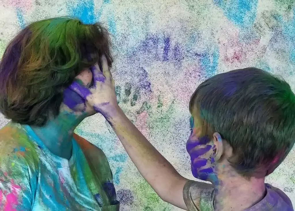Mother and son having fun together being willing and enjoying the Festival of Colors.